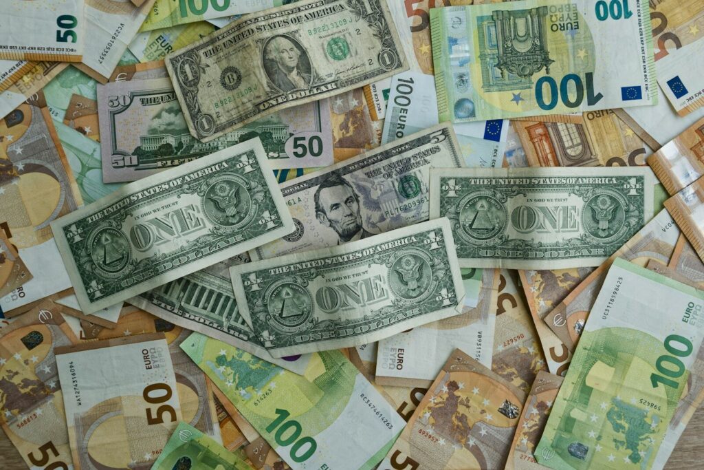 Us dollars and euros scattered on a surface.